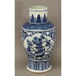 A CHINESE BLUE AND WHITE BALUSTER VASE, lobed panels of still life arrangements with a prunus
