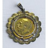 A 9CT GOLD MOUNTED GEORGE V SOVEREIGN PENDANT the coin dated 1912, within a lobed and engine-