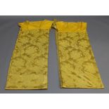 A PAIR OF LATE 19TH CENTURY FRENCH DAMASK CURTAINS with integral pelmets, golden colour with foliate