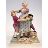 Faience figure group,   modelled with two children trying to steal fruit from a vendor, joined