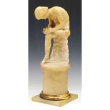 Alabaster figure of the spinario after the antique, 19th century, height 23cm, on a turned pedestal,