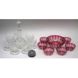 Ruby chased glass dessert set, a millefiori paperweight, a cut glass decanter and six bowls.