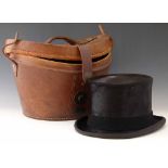 Antique brown leather top hat case containing a dressage top hat by Herbert Johnson. Condition