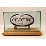 Gilbert rugby ball in a glass case, "Welsh Heroes" signed at Millennium Stadium, Cardiff 2005,