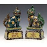 Pair of Chinese opposing lions of Fo, painted in enamels, height 28cm.