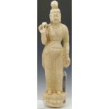 South east Asian carved white stone figure Guanyin, standing on a lotus pod, height 55cm.