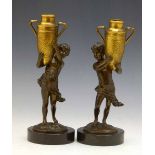 Pair of gilt and patinated spelter figures of cherub water carriers, on circular marble bases,