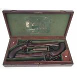 Pair of flintlock duelling pistols by Manton London,   with a period case containing powder flask,