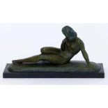 Green patinated bronze figure after Ugo Cipriani (1897 - 1960) of a reclining female, on black