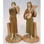 Pair of Royal Worcester figures of Egyptian Musicians  modelled playing a tambourine and a harp,