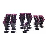 Part suite of twenty five Victorian purple glasses   in four different graduated sizes; 6 x 16.