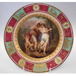 Vienna type plate,   painted with figures and a cherub painting at an easel, within raised gilt
