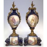Pair of French ormolu mounted pottery garnitures,   painted with figures in landscapes on blue and