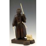 Japanese wood and ivory figure of a samurai weilding two swords, incised mark to base, height 25cm