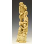 Japanese ivory okimono of a fisherman standing on a rock with a boy, late Meiji period, height