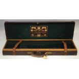 Joseph Lang & Son shotgun case  of oak, leather and brass construction, green felt interior with