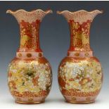 Pair of Japanese Kutani vases, Meiji period, the globular body and trumpet neck painted in iron red,