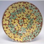 Della Robbia dish   incised by Harry Fletcher and painted by Annie Jones with closely packed