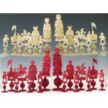 Chinese red and white ivory chess set, late 19th century, the pieces carved as courtly figures, each