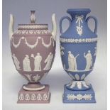 Two Wedgwood jasperware twin handled vases decorated with classical figures on lilac and light