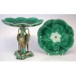 Majolica comport and a plate, moulded as lilies the comport supported by three heron on triform