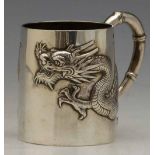 China Trades beaker embossed with a dragon, maker's mark OGHM and a character, height 7cm.