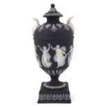 Wedgwood solid black jasper twin handled lidded vase, decorated with classical figures, impressed
