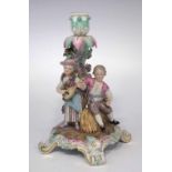 Meissen candlestick figure group  modelled with a girl playing a mandolin beside a seated boy on