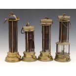 Three Newcastle type Davy safety lamps with exposed iron gauze sleeves and brass bodies, height