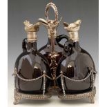 Victorian silver plated decanter stand of three brown glass decanters with hinged covers and