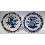 Two Delft plates  painted with a basket of flowers and floral rockwork scene in underglaze blue,