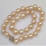 Fresh water pearl necklace, of 33 beads +/-12.5mm, pinkish, on magnetic clasp set with crystals,