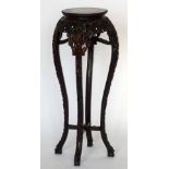 Chinese carved hardwood jardinière stand, the inset marble top on four re-curved legs, height 90cm.