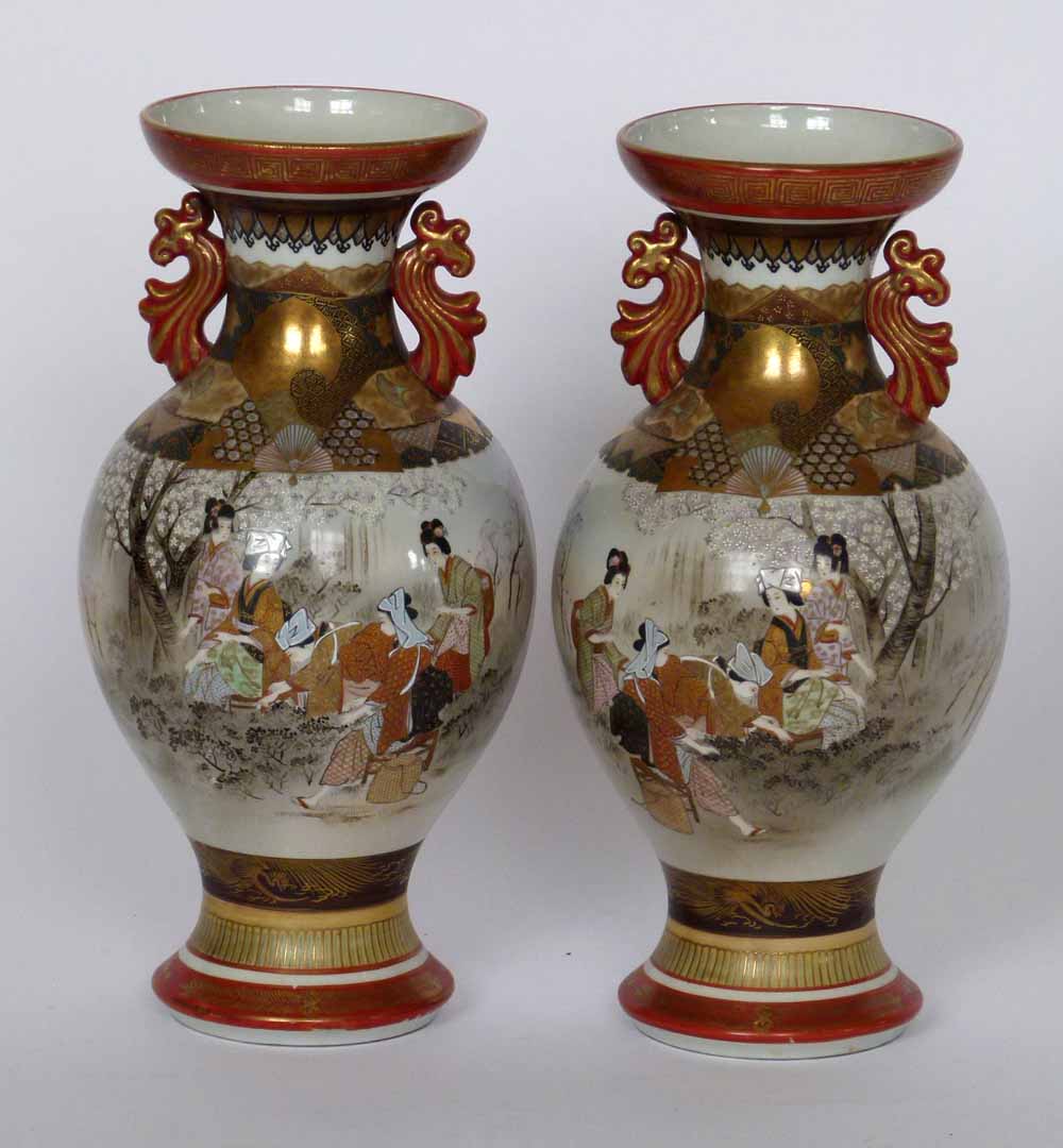 Pair of Japanese Kutani porcelain baluster vases painted in iron red and gilt with a continuous