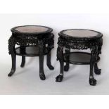 A Chinese hardwood low table, with an inset marble top on carved frame and lower shelf, diameter