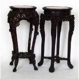 A Chinese hardwood jardinière stand, the inset marble top on a carved foliage frame, height 92cm,