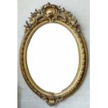 Gilt wood and gesso Georgian style wall mirror, circa 1900, the oval bevelled plate in an egg and