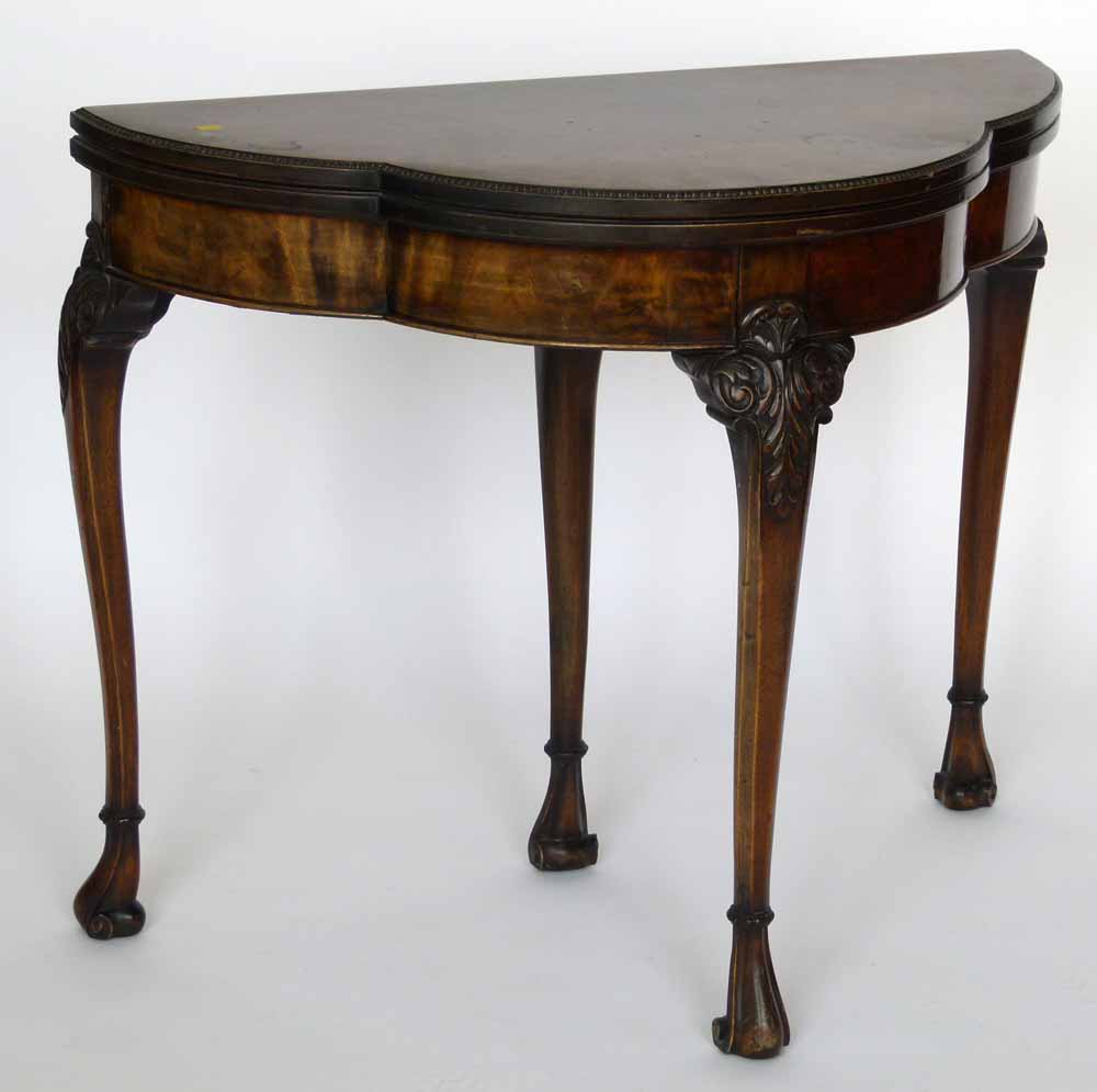 Chippendale style figured mahogany trefoil fold over card table, 20th century, on one sliding and