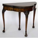 Chippendale style figured mahogany trefoil fold over card table, 20th century, on one sliding and