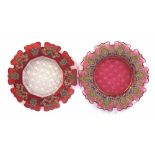 Two Bohemian ruby glass enamelled plates with shaped rims and cut bases, mid-19th century, (2)