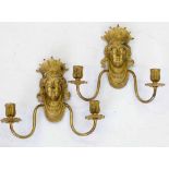 Pair of gilt metal neo classical female mask wall sconces with two scrolling branches, overall