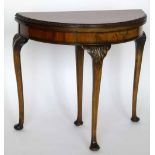 Figured walnut half-moon fold over card table, 20th century, on one sliding and three static leaf