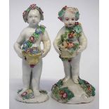 Two figures of cherubs by Bow and Derby 1760 -1780 both modelled with baskets of flowers, (2) 12.5cm