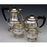 Four piece silver tea set, each with a compressed globular body, DNH&S, Sheffield 1944, ebonised