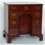 Georgian mahogany kneehole desk or dressing table of one long and six short drawers flanking a