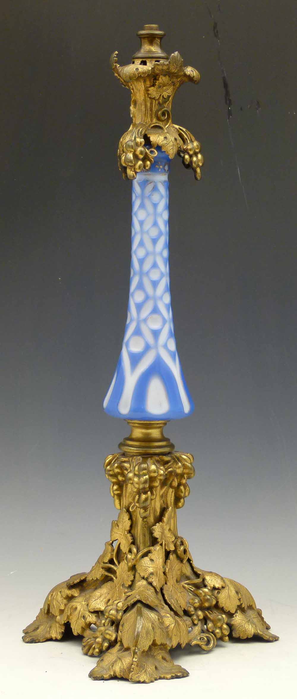 OIl lamp stem of blue and white cased glass and gilt brass mounts of vines, circa 1880, height