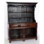 Oak dresser mid 18th century, the boarded canopy back of two shelves and an open work frieze on a