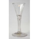 Mid-18th century wine glass with flaring bowl plain stem with tear inclusion, and folded foot,