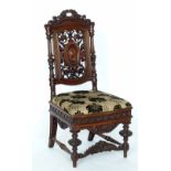 Louis XIII style walnut side chair, the high back carved with leaf scrolls on a stuffed seat.