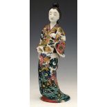 Japanese porcelain figure of a bijin in floral robes, height 31cm.